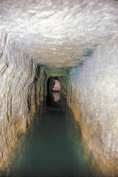 A young boy wades through Hezekiah’s Tunnel, the most famous of the Jerusalem tunnels. The image brings to mind the discovery of the Siloam Inscription—located at the southern end of Hezekiah’s Tunnel—by a youth in 1880. Photo: Hershel Shanks